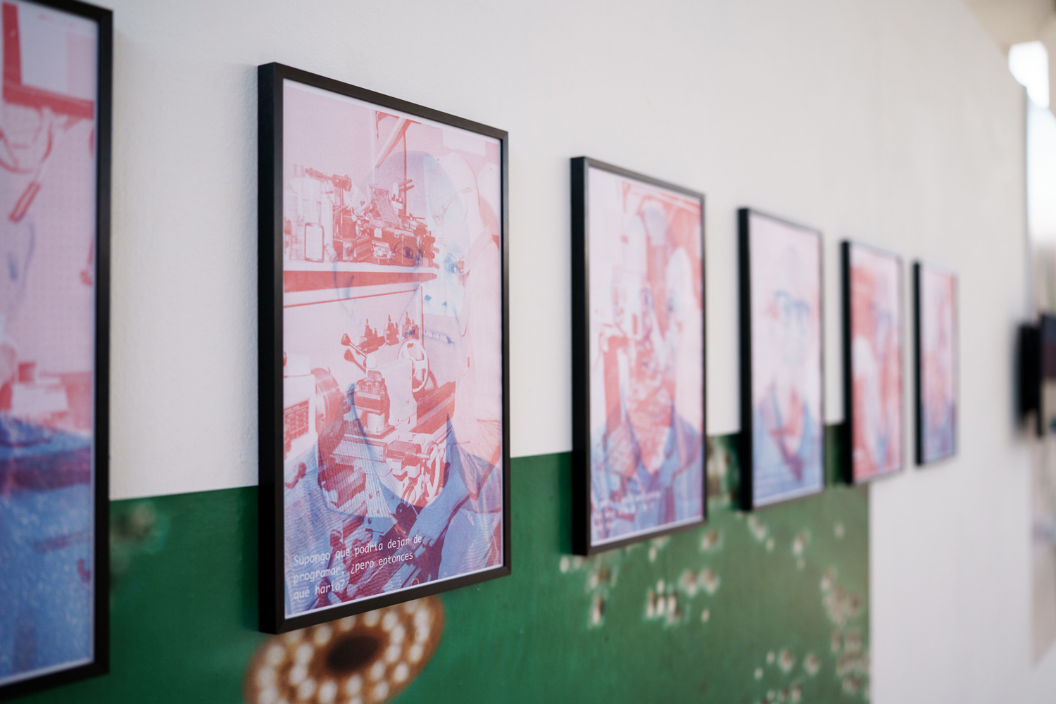 Row of framed risograph posters mounted on a wall printed with a green circuit-board photograph, from the Dreams and Hallucinations installation